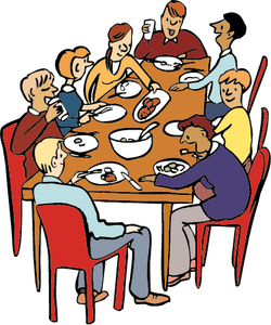 Eine Gruppe von Menschen sitzt um einen Tisch und isst gemeinsam.